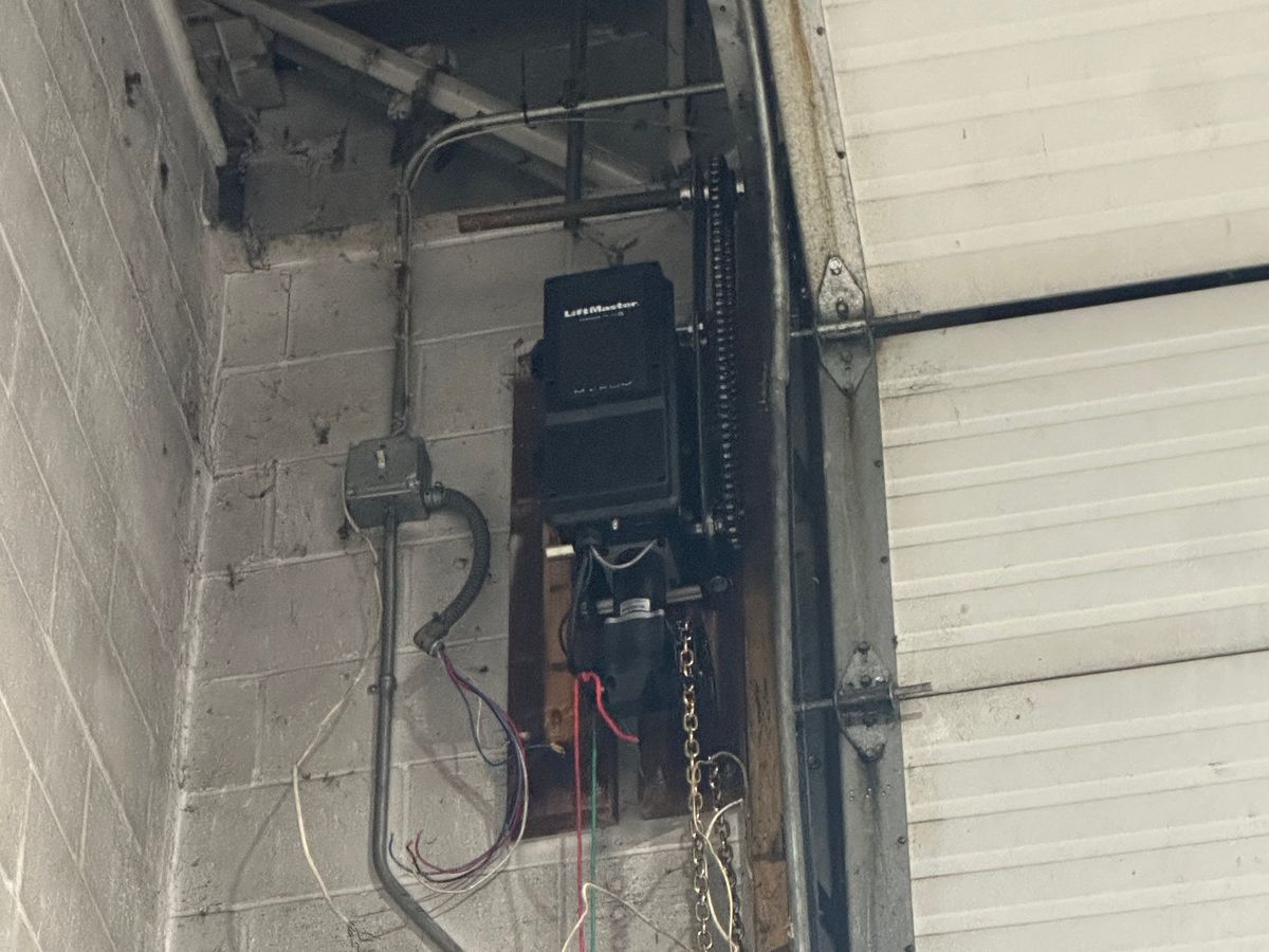 Close-up of LiftMaster opener motor and chain drive installation in MA garage